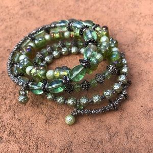Green crystal and silver tone wrap bracelet